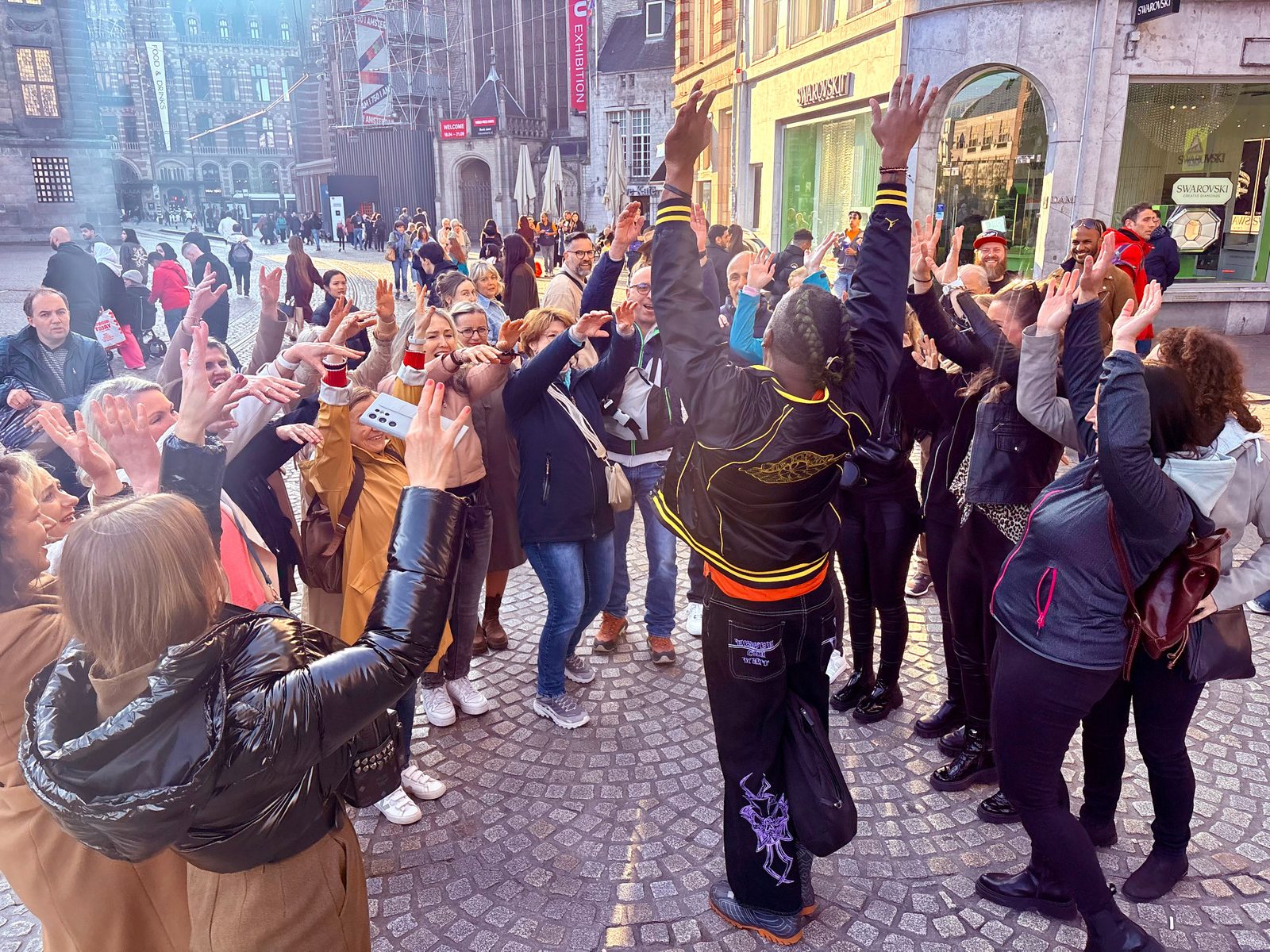 Lively crowd on Amsterdam cobblestones during a tour experience