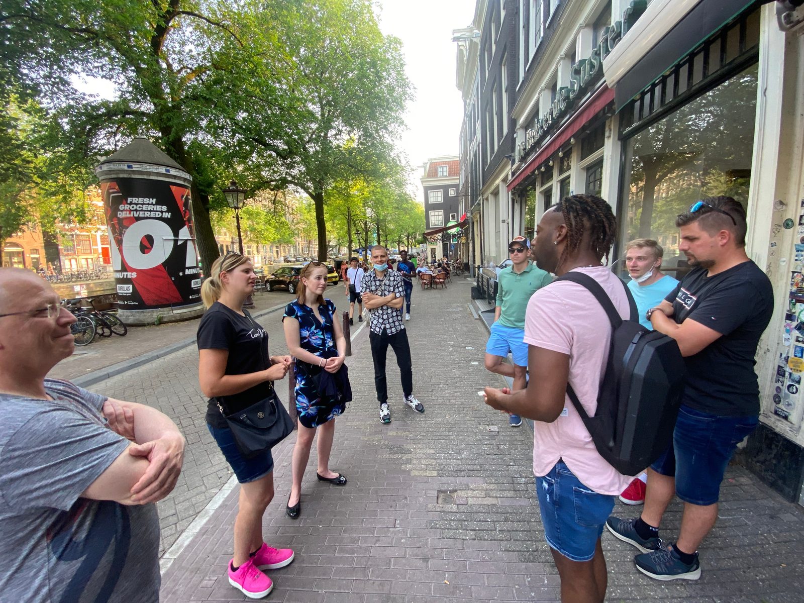 Private host with a small group on an Amsterdam street during a concierge day