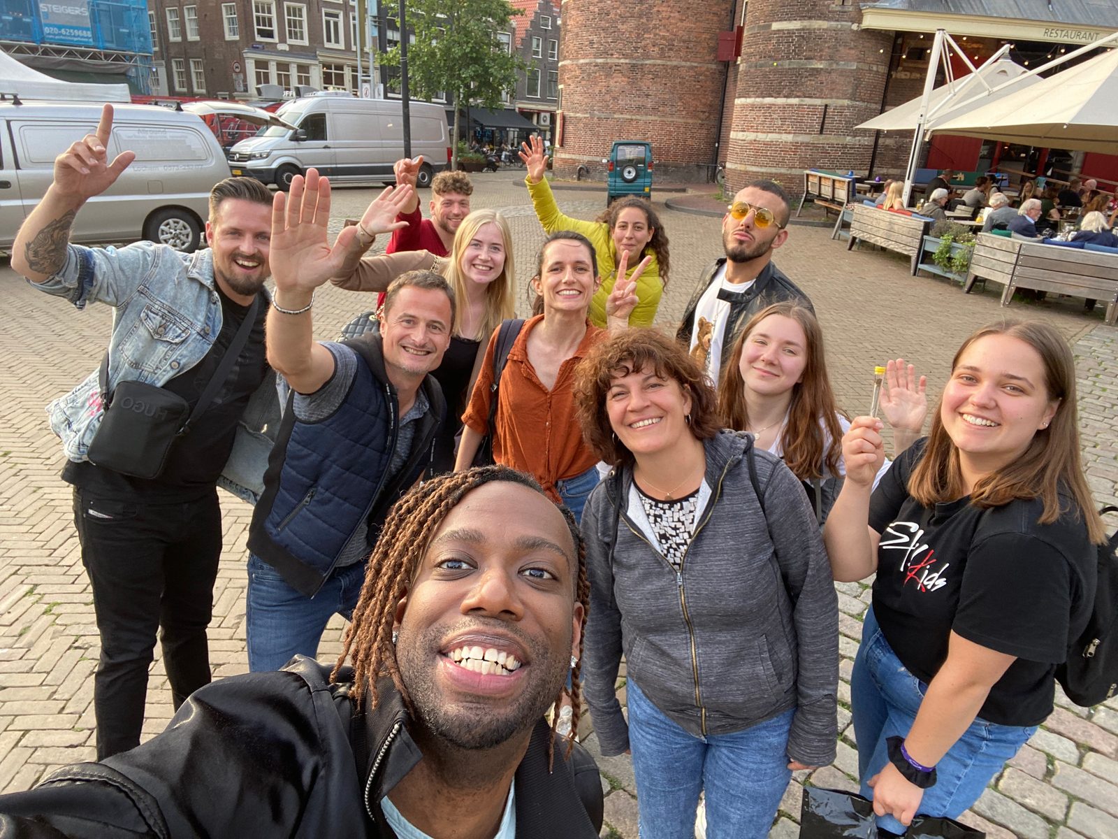 Tour group selfie at an Amsterdam landmark